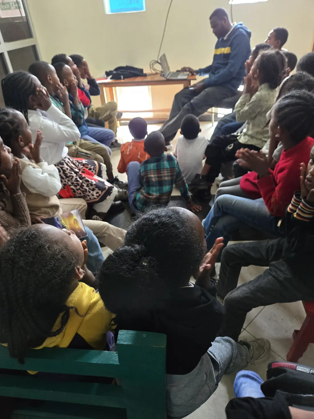 Children listen to a presentation in the library.