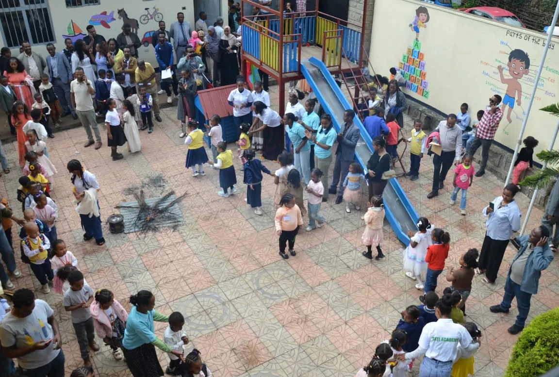 A view from above of families and children gathered around the playground.