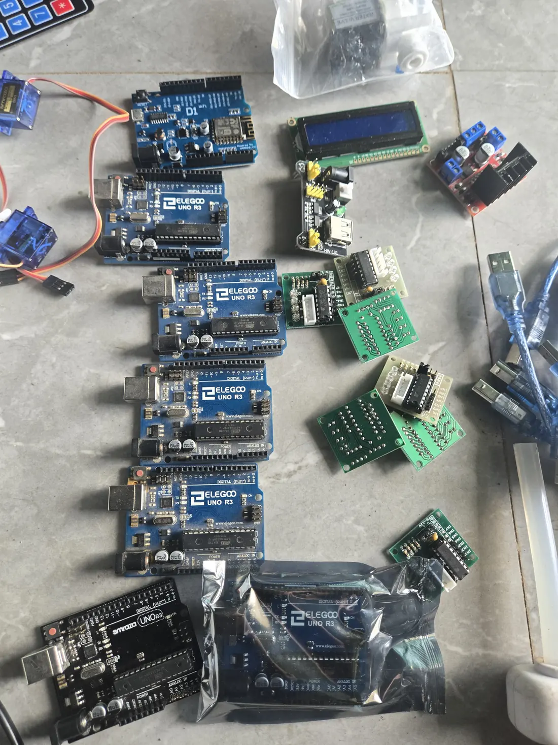 Arduino boards, sensors and an LCD screen laid out for a STEM session.